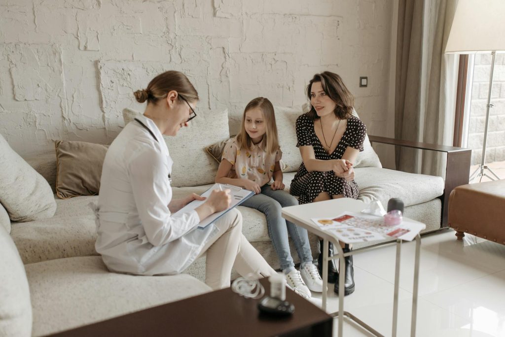 a doctor in a consultation with a mother and her daughter